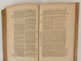an open book on a table with a white background