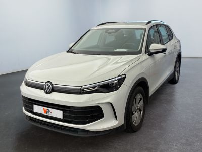 the white volkswagen suv is parked in a room with a black floor