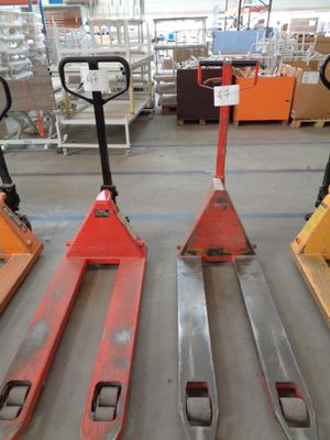 several pallets are lined up in a warehouse with pallets in the background