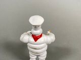 a small figurine of a chef with a red bandanna