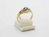 a close up of a gold ring with a blue stone on it