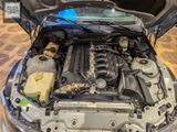 the engine of a car with its hood open on a tiled floor