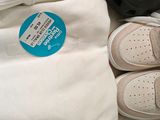 two pairs of shoes and a t - shirt on a table