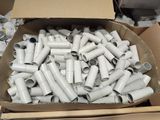 a cardboard box full of white pipes and fittings
