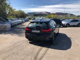 cars are parked in a parking lot in front of a building