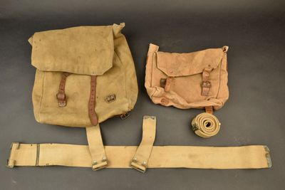 two bags and a belt are sitting on a table