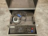a metal box with a machine in it in a garage