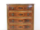 an antique chest of drawers with a marble top