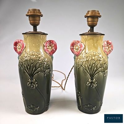 two vases that have been decorated with flowers on them