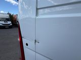 a white van that is parked in a parking lot