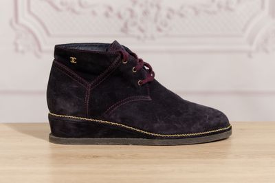 a close up of a pair of shoes on a wooden table