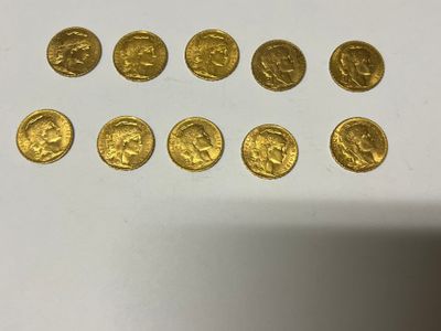 a bunch of gold coins sitting on top of a white table