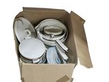 a cardboard box with a bunch of dishes and pans in it