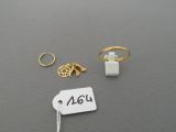 two rings, a ring, and a ring with a price tag on a table