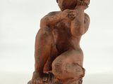 an image of a statue of a woman sitting on a rock