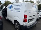 a white van parked in a parking lot with its door open