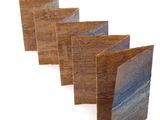 four pieces of wood are stacked on top of each other