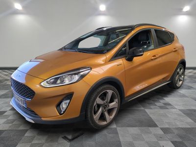 a orange ford fiesta parked on a checkered tile floor