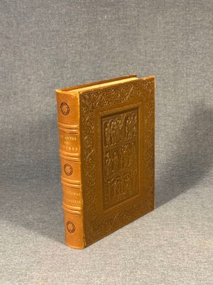 an old book sitting on top of a table next to a cup of coffee