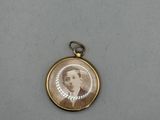 an antique photo of a man in a suit and tie is shown in a gold locke