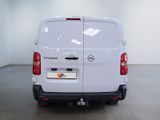the back of a white van is parked in a large room