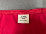 the label on the back of a red dress