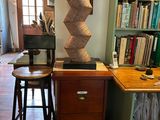 a desk with a chair and a lamp in a room