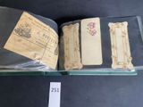 an open book sitting on top of a table next to a piece of paper