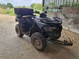 a black atv with a basket on the back of it