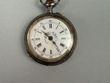 a silver pocket watch with roman numerals on it