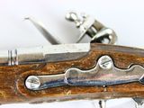 a close up of a gun on a white surface