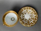 a close up of a cup and saucer on a table
