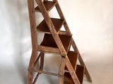 a wooden ladder that is leaning up against a wall