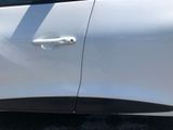 a close up of a door handle on a white car