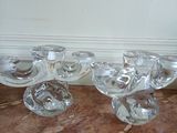 four clear glass bowls sitting on a marble table