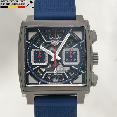 a close up of a watch with a blue strap