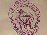 the logo on the back of a white shirt with a purple lion on it