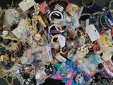 a pile of assorted necklaces and bracelets on a table