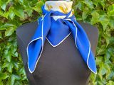 a mannequin with a blue and white scarf on it