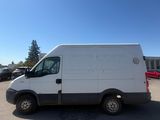 a white van parked in a parking lot with a blue sky in the background