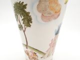 un vase avec une peinture sur une surface blanche