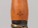 a close up of a wooden object with a metal ring on it