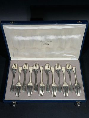 six fourchettes dans un étui bleu contenant de l'argenterie