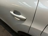 a close up of a door handle on a white car