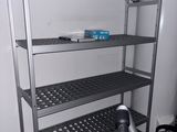 a metal shelf with pots on top of it