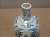 a blue and white vase sitting on a table