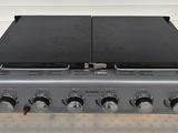 an image of a gas stove with four burners on top of it