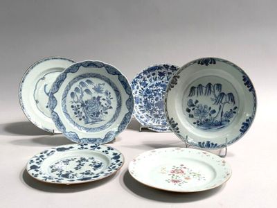 several blue and white plates with designs on them sitting on a table