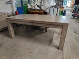 a wooden table with a boat on it in a room