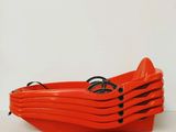 an orange plastic boat that is sitting on a table